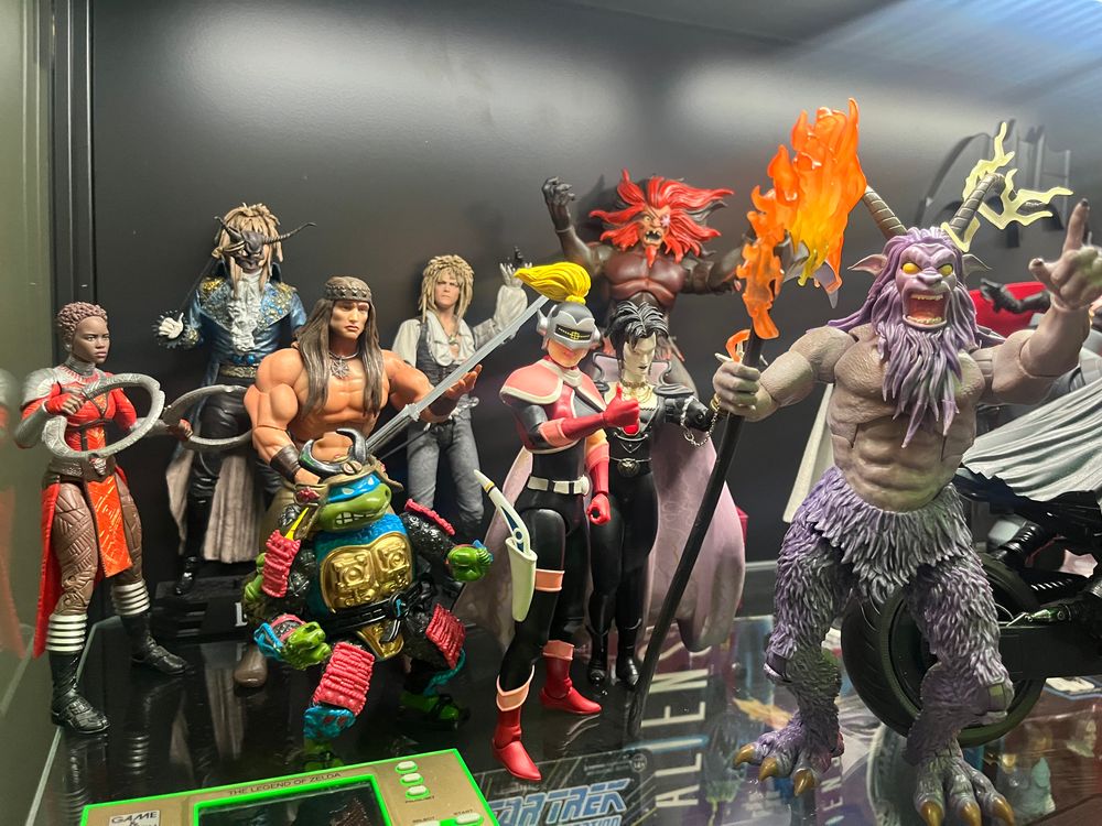 A collection of action figures on a shelf