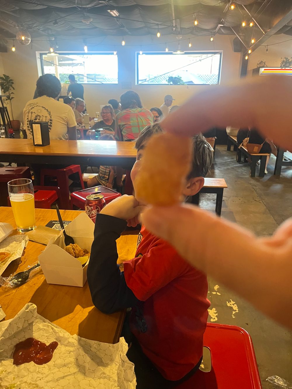 A photo of my son with a tater tot eclipsing his head