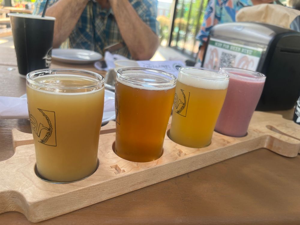 A row of 4 small multicolored beer 